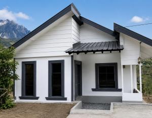 a white house with a black roof at Triple A Kundasang in Ranau +4 photos
