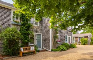 a house with a bench in front of it at The Lightkeeper’s Inn in Edgartown