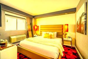 a bedroom with a large bed and a window at Hotel Kalika Inn in Dhanbād