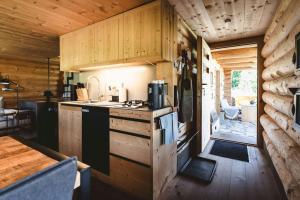 a kitchen with a stove and a table in a cabin at Maiensäss, Berghütte Chlara - autark, voll ausgestattet, Ressourcen begrenzt in Untervaz +21 photos