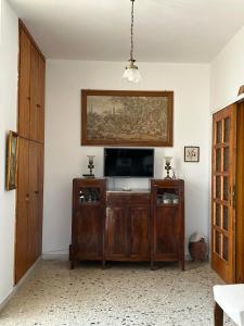 a living room with a flat screen tv in a room at Minimalist Serenity Vravrona - Airport Stay in Vravrona