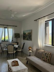 a living room with a couch and a table at Minimalist Serenity Vravrona - Airport Stay in Vravrona
