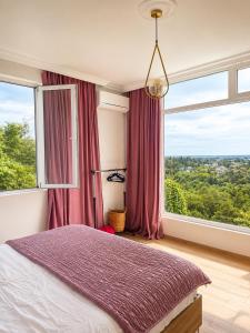 a bedroom with a bed and a large window at Kibula Horizon in Ureki