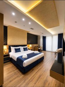 a hotel room with a large bed and a desk at The New Jai Son in Kobuleti +46 photos