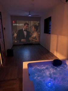 a man and woman standing in a room with a tub at Vishwakarma Niwas Jacuzzi Villa with Pool in Thane