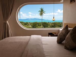 a bedroom with a large window and a bed at CASA MARINe in Bophut
