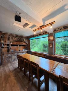 a dining room with a large wooden table and chairs at Vikendica Brda in Banja Luka