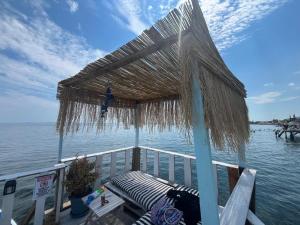 a pergola on the back of a boat on the water at Deniz Kenarı Beach & Garden in Ayvacık