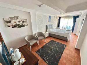 a bedroom with a bed and a living room at Deniz Kenarı Beach & Garden in Ayvacık +10 photos