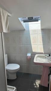 a bathroom with a toilet and a sink at A Casa do Peregrino in A Guarda