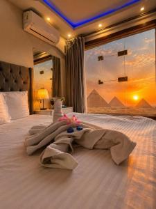 a bedroom with a bed with a blanket on it at ImhOtep pYramids HOtel in Cairo
