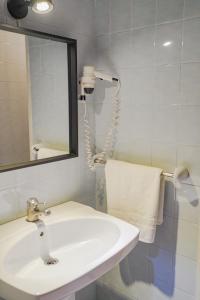 a bathroom with a sink and a mirror and a phone at Hotel Marqués de la Moral in Naveces +30 photos