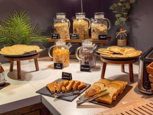 a buffet with various types of bread and other foods at ibis Nîmes Ouest - A9 in Nîmes