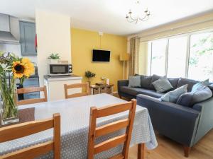 a living room with a couch and a table at 15 The Dell in Norwich