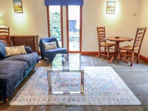 a living room with a couch and a glass table at Owl Cottage in Woodbridge +9 photos
