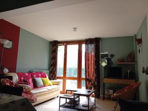 a living room with a couch and a window at Maison de vacances Pradines in Pradines