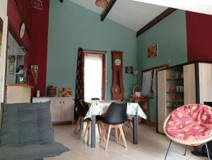 a dining room with a table and chairs at Maison de vacances Pradines in Pradines +4 photos