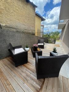 a patio with chairs and tables on a wooden deck at Pramanta Nest in Pramanta +1 photo