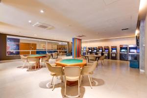 a restaurant with tables and chairs and ping pong machines at Enjoy Olímpia Park Resort in Olímpia +30 photos