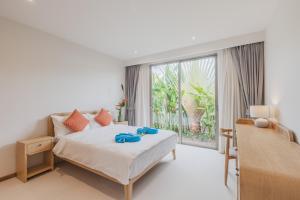 a bedroom with a bed and a large window at Luxury 3-Bedroom private pool villa Trichada Breeze in Phuket +67 photos