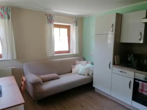 a living room with a couch in a kitchen at Ferienwohnung Mittergutnigg in Innervillgraten