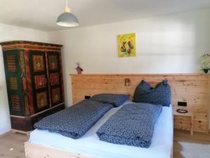 a bedroom with two beds with blue pillows at Ferienwohnung Mittergutnigg in Innervillgraten
