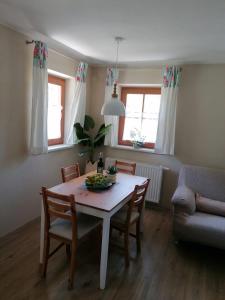 a living room with a table and chairs and a couch at Ferienwohnung Mittergutnigg in Innervillgraten +11 photos