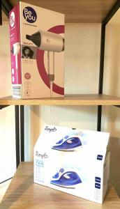 a box sitting on a shelf next to a hair dryer at Weaky what you want in Ugine