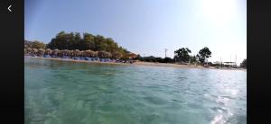 a view of a beach with chairs and the water at Casa Patronimio Aristotle Socrates Residence in Ierissos