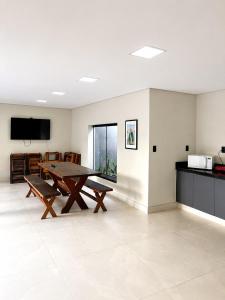 a living room with a table and a kitchen at Vila inn hotel in Brasília +35 photos