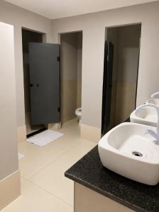 a bathroom with a sink and two toilets at Vila inn hotel in Brasília