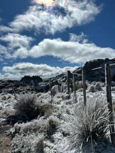 a fence in the desert with snow on the ground at Rinconcito Serrano in Mina Clavero +2 photos