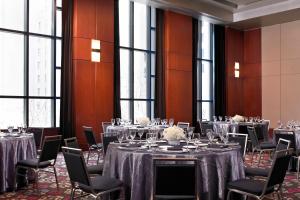 a conference room with tables and chairs and windows at W Seattle in Seattle
