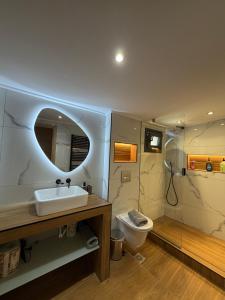 a bathroom with a sink and a toilet at Diktamo Village House in Ofrínion