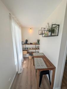 a room with a wooden table and a window at Agréables chambres indépendantes - Coutances centre in Coutances