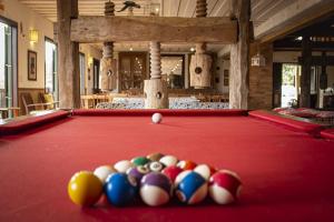 a pool table with balls on top of it at Pousada Engenho da Lagoa in Garopaba
