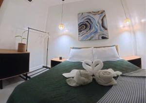 two swans are sitting on top of a bed at The Retreat in Panglao Island +32 photos