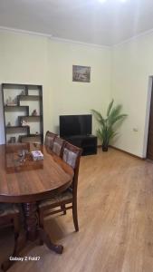 a living room with a wooden table and a couch at Cozy Townhouse in Yerevan