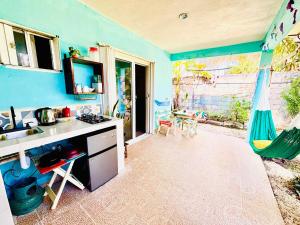 a kitchen with a sink and a counter top at Garden House 2 bikes included in Mahahual