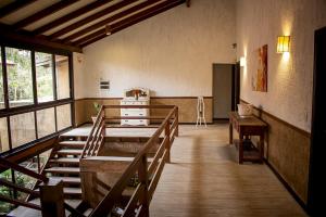 a room with a table and chairs in a building at Pousada Engenho da Lagoa in Garopaba