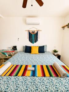 a bedroom with a large bed with a colorful rug at Garden House 2 bikes included in Mahahual
