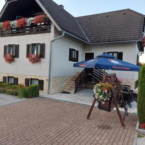 a blue umbrella sitting in front of a building at house Anna in Plitvička Jezera