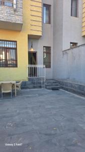 a building with a table and chairs in front of it at Cozy Townhouse in Yerevan +21 photos