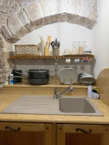 a kitchen with a sink and a counter top at Casa La Grotta in Bitonto +30 photos