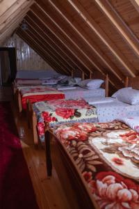 a group of beds sitting in a room at Bujtina Mitaj in Vermosh