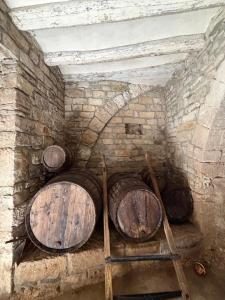 a stack of wooden barrels in a brick wall at Cal Rabell in Bellmunt