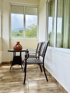a chair and a table in front of a window at Silver Green Resort in Wayanad