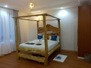 a bedroom with a wooden bunk bed in a room at Goldenview Gardens Elementaita in Gilgil