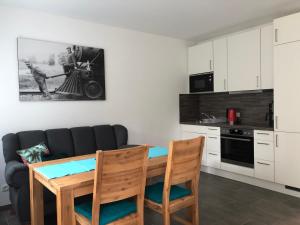 a living room with a table and a couch at Ferienwohnung26 in Blankenfelde +15 photos