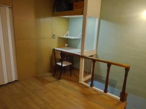 a small room with a desk and a stair case at Los abuelos 28 in Estación La Dorotea